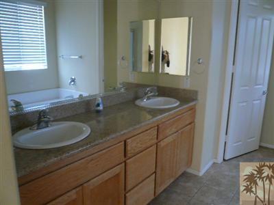 49590 Lewis Road Indio, CA 92201 - Photo 9 of 20 a bathroom with a double vanity sink and a mirror