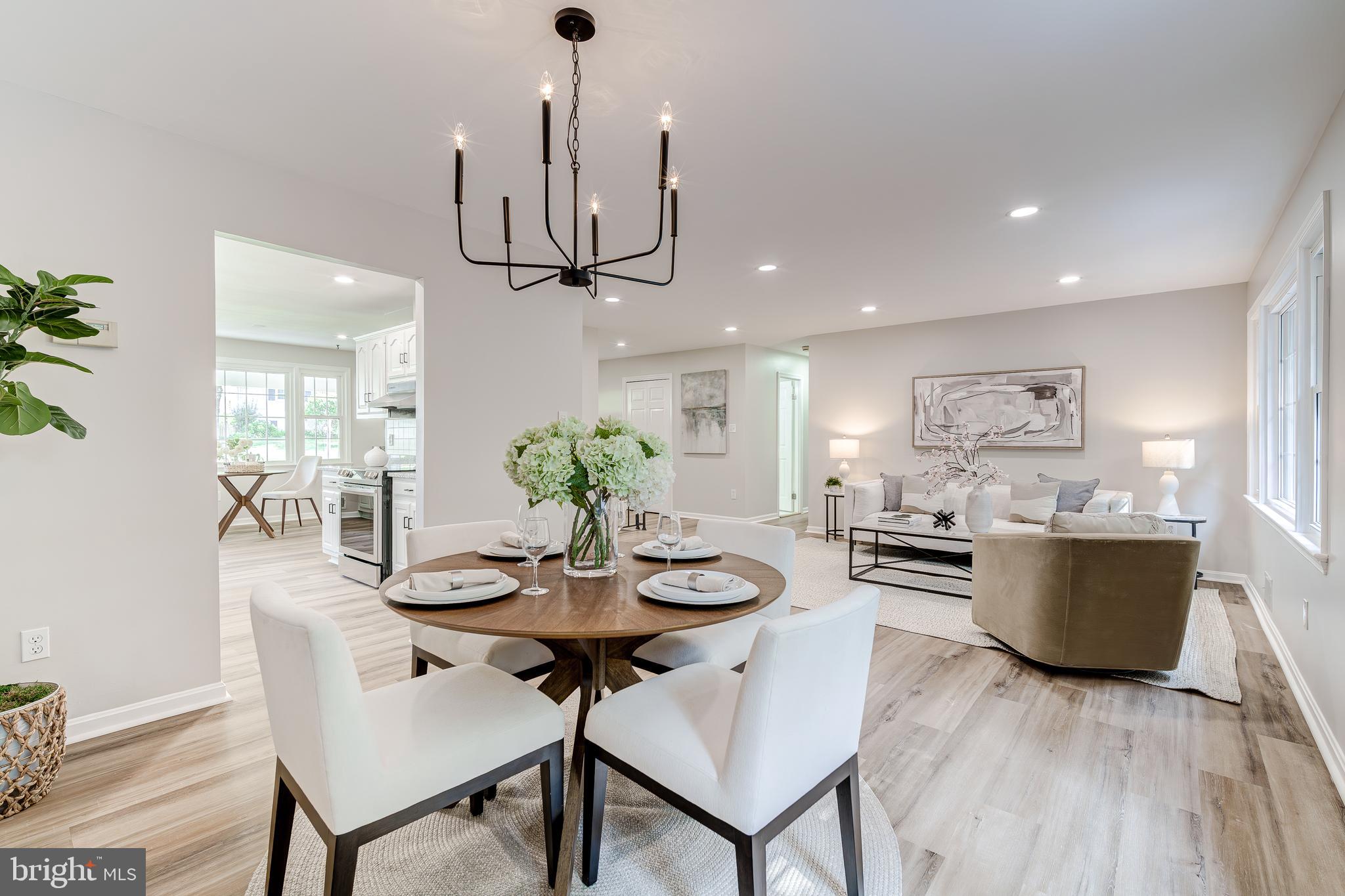 6803 Houndmaster Road Springfield, VA 22152 - Photo 11 of 44 a view of a dining room with furniture wooden floor and chandelier