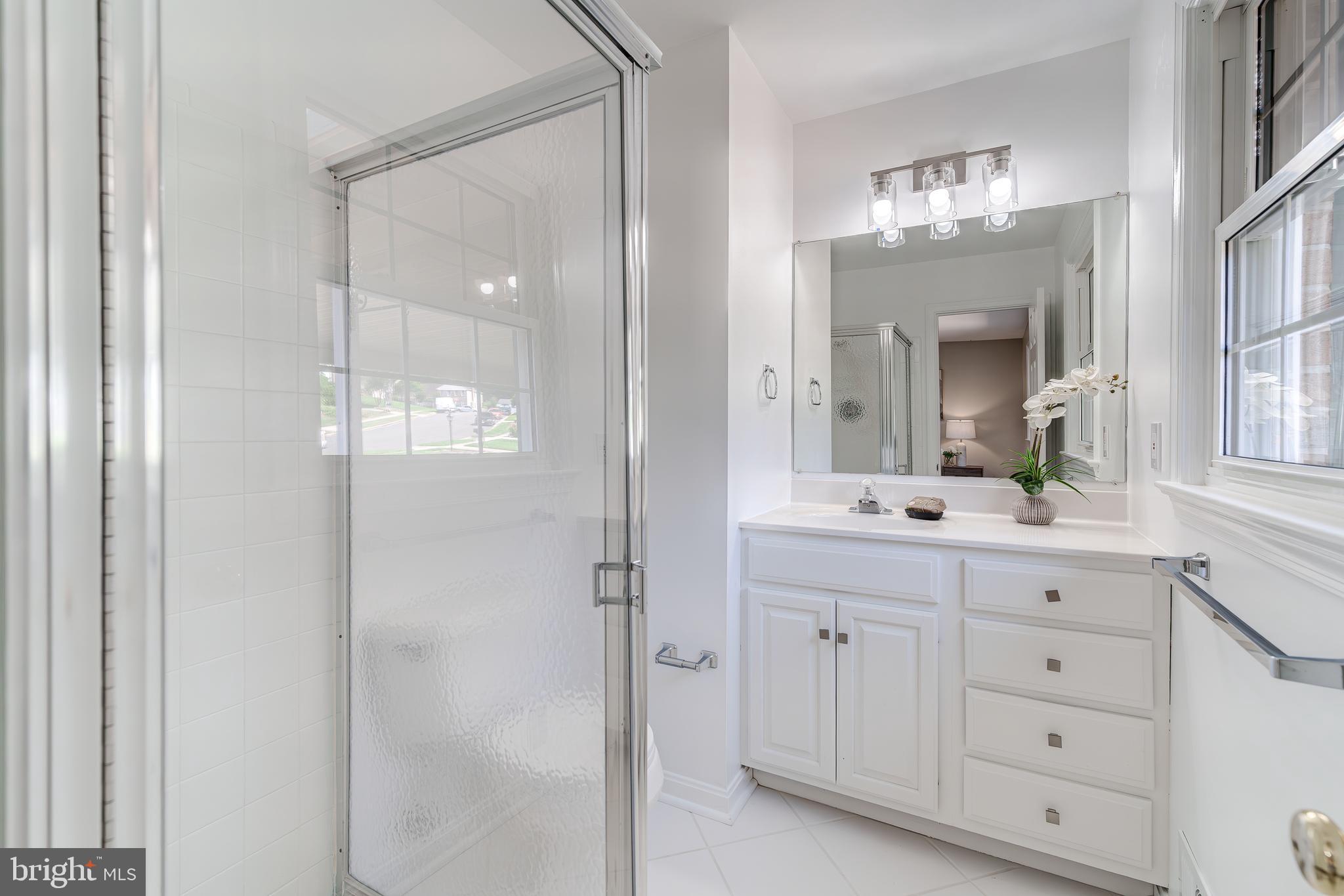 6803 Houndmaster Road Springfield, VA 22152 - Photo 24 of 44 a bathroom with a double vanity sink and mirror