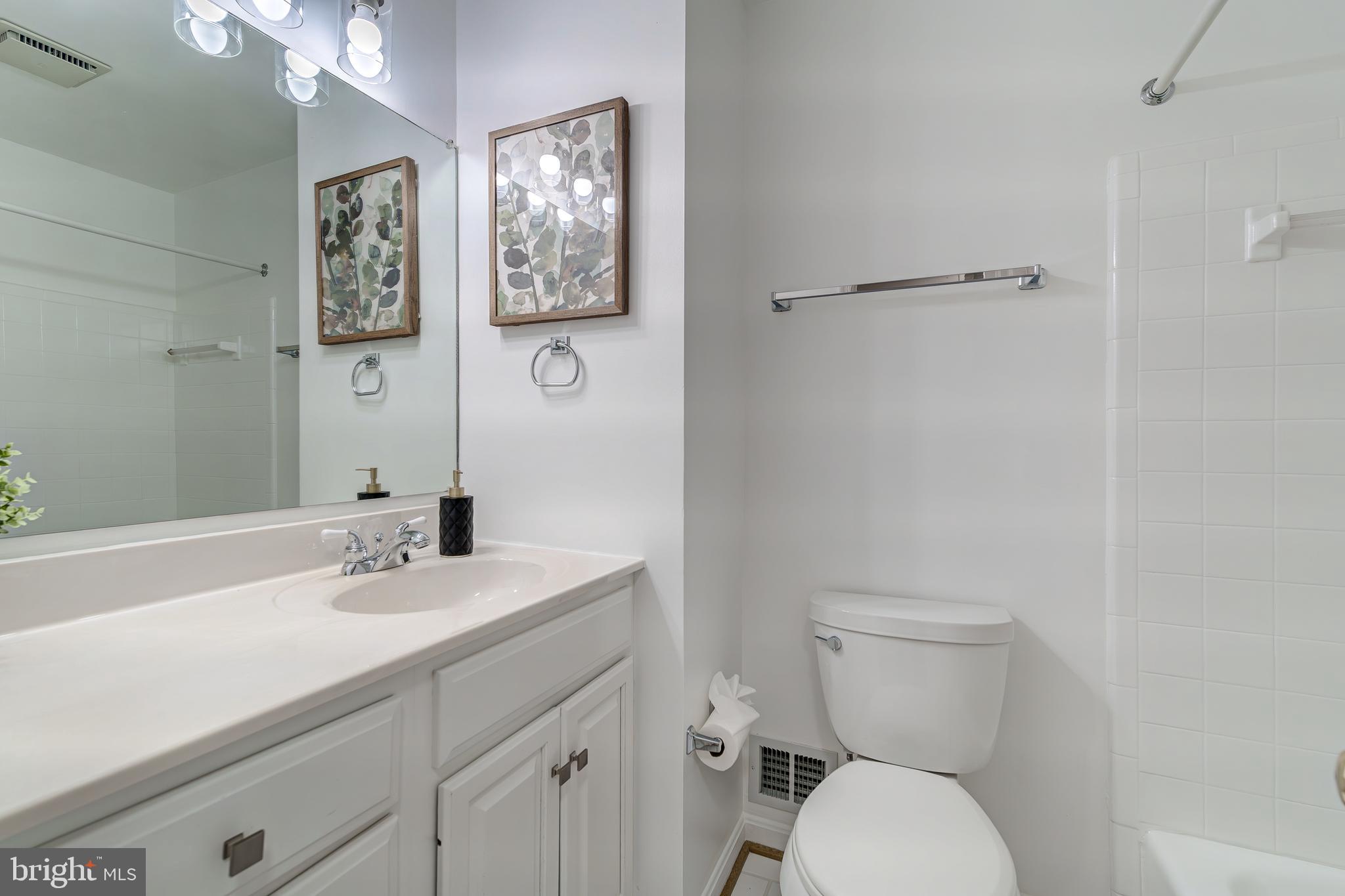 6803 Houndmaster Road Springfield, VA 22152 - Photo 29 of 44 a bathroom with a sink mirror and toilet