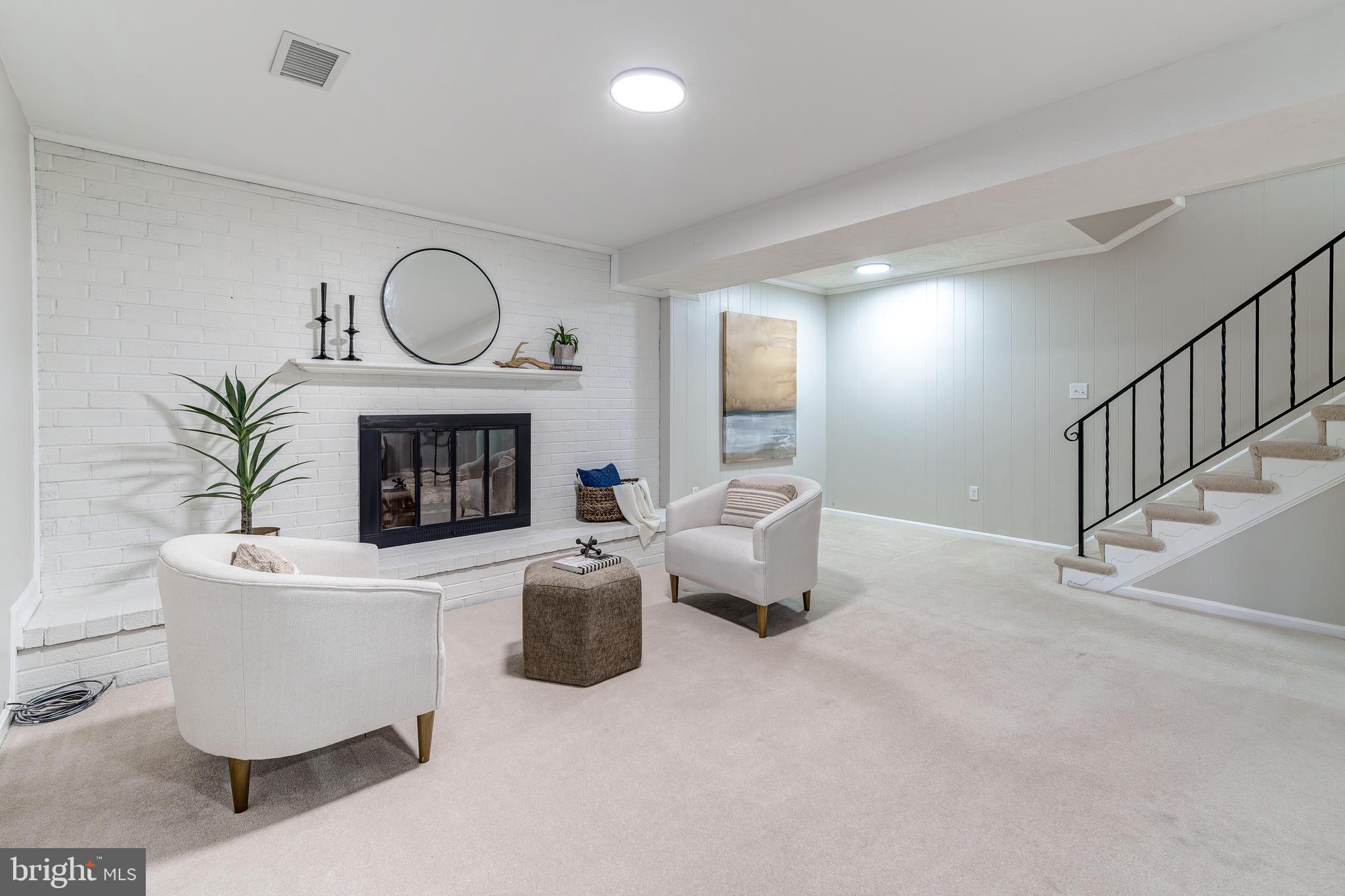 6803 Houndmaster Road Springfield, VA 22152 - Photo 33 of 44 a living room with furniture a fireplace and a potted plant