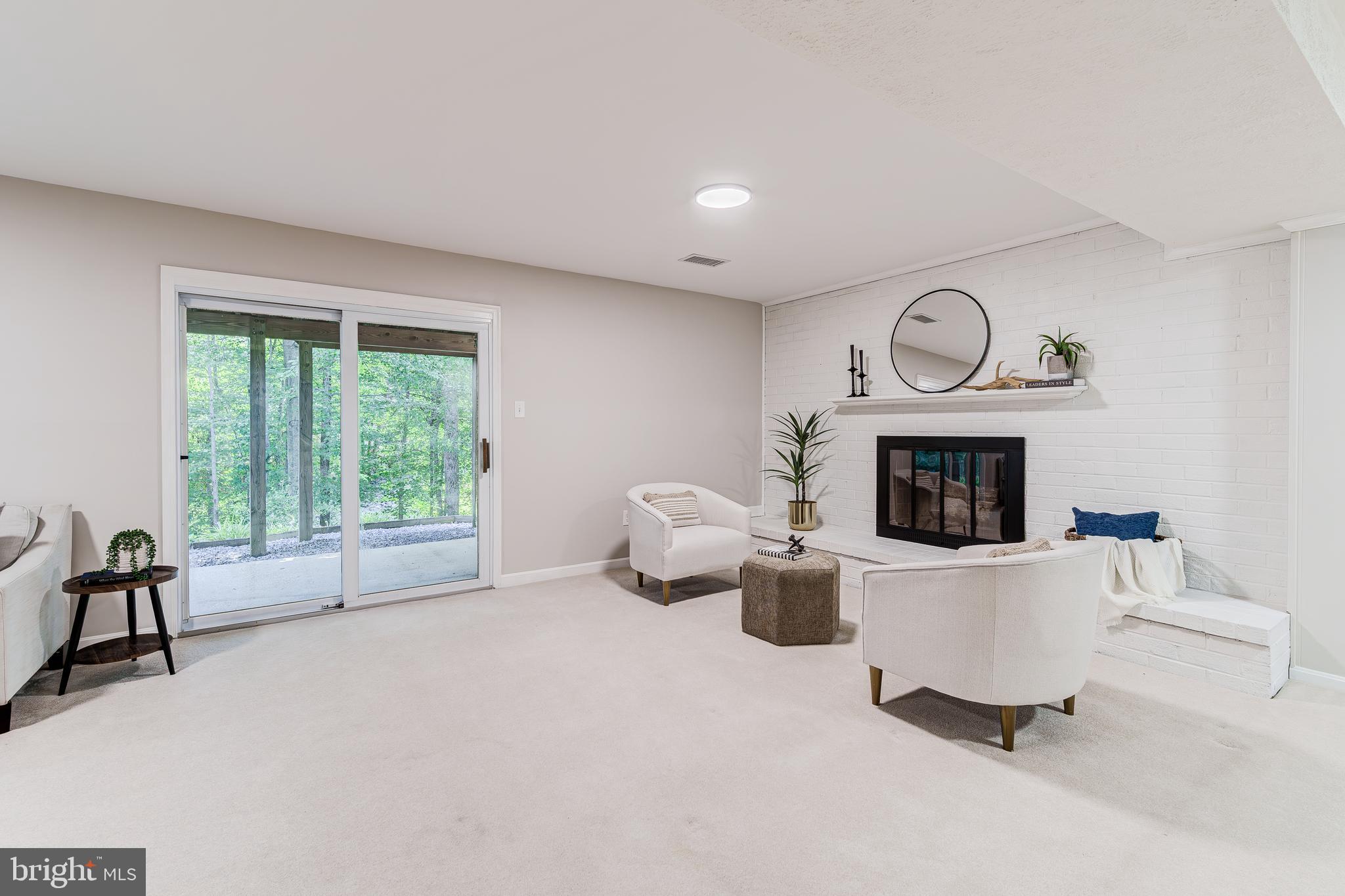 6803 Houndmaster Road Springfield, VA 22152 - Photo 35 of 44 a living room with furniture and a fireplace