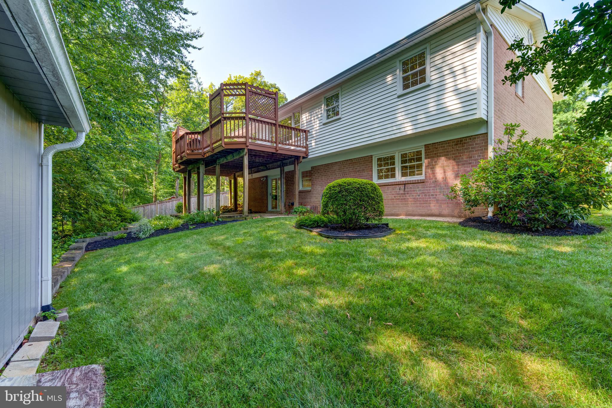 6803 Houndmaster Road Springfield, VA 22152 - Photo 4 of 44 a front view of a house with a garden