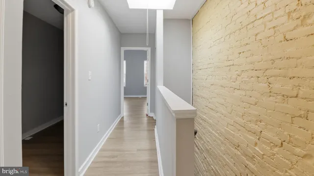 a view of an empty room and wooden floor