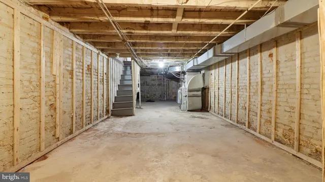 a view of a kitchen with wooden floor and staircase