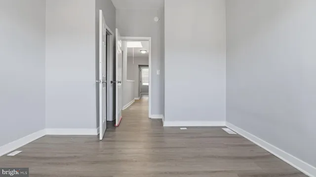 a view of a room with wooden floor