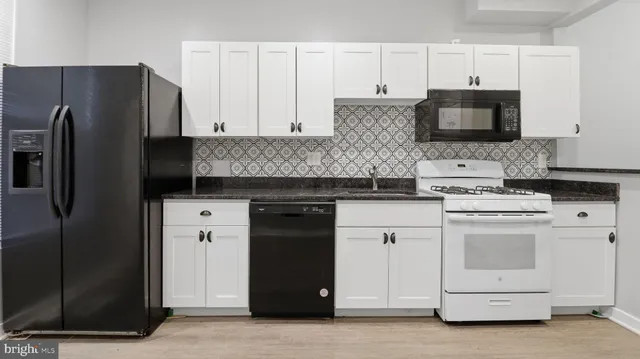 a kitchen with a refrigerator stove and microwave