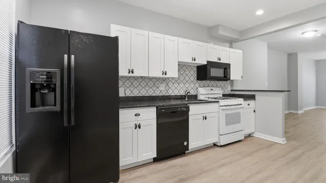 a view of staircase with white walls and railing