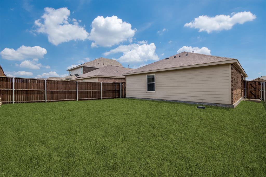 1345 Cider Street Forney, TX 75126 - Photo 15 of 15 a view of a backyard with a garden