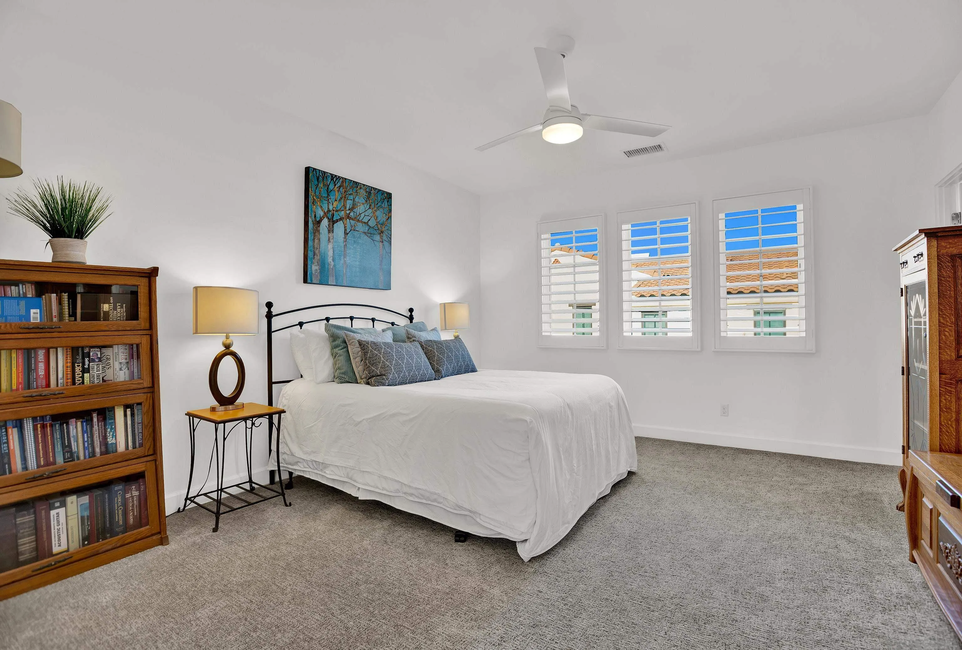 946 Pearl Drive San Marcos, CA 92078 - Photo 35 of 42 a bedroom with a bed and a book shelf