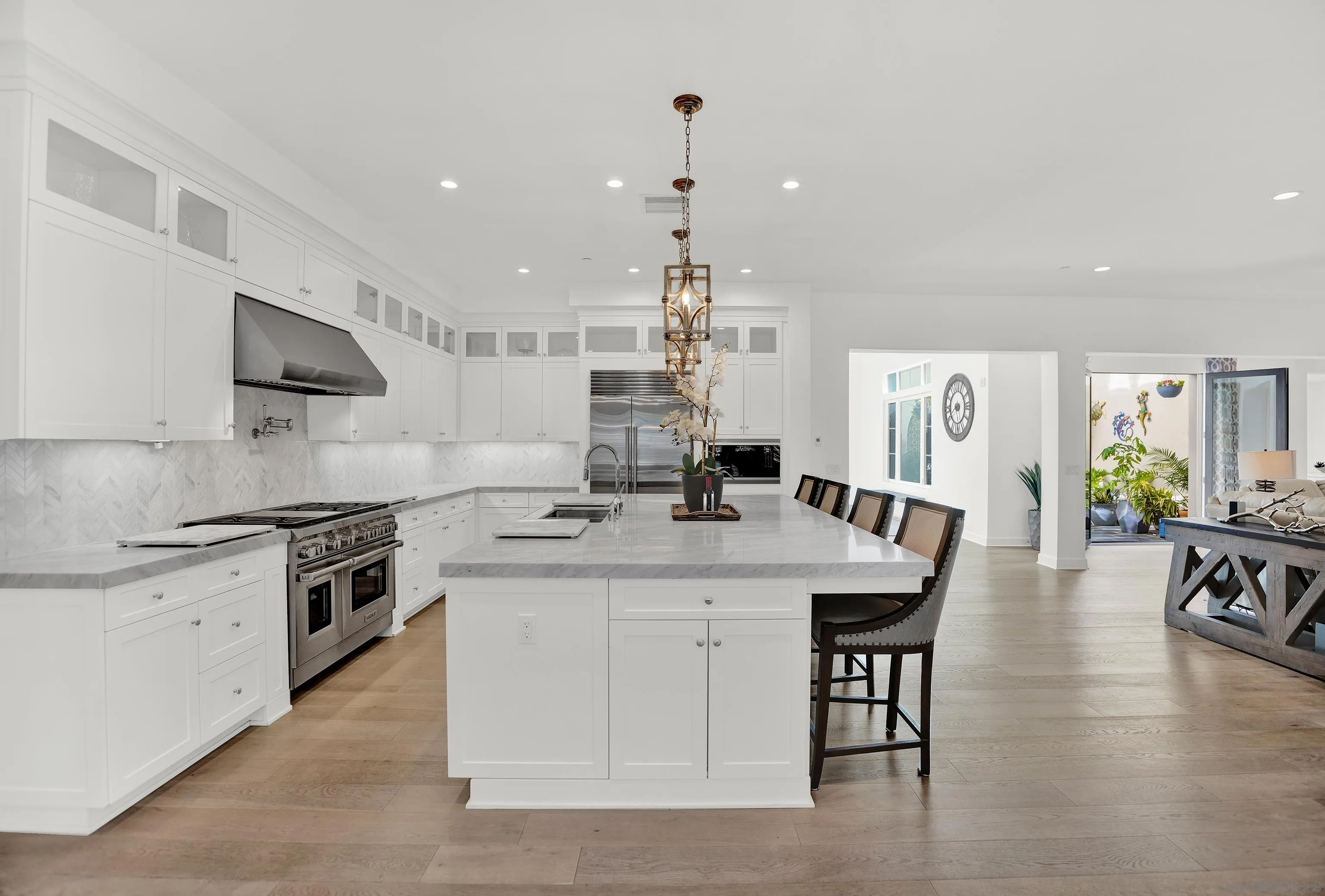 946 Pearl Drive San Marcos, CA 92078 - Photo 8 of 42 a large kitchen with kitchen island a sink table and chairs