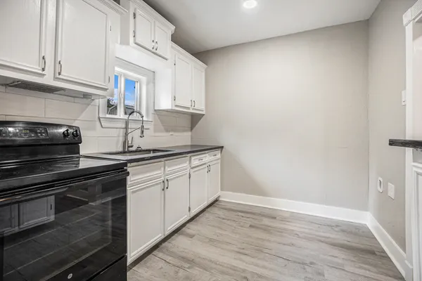 a kitchen with a sink and cabinets