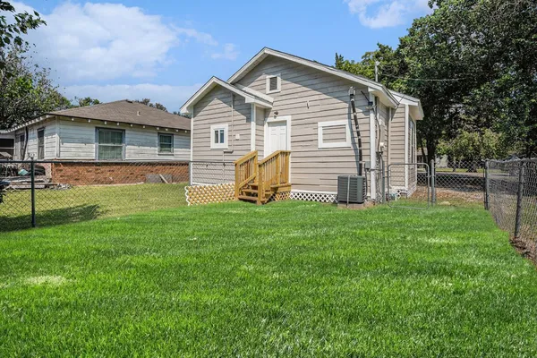 a front view of house with a garden and deck