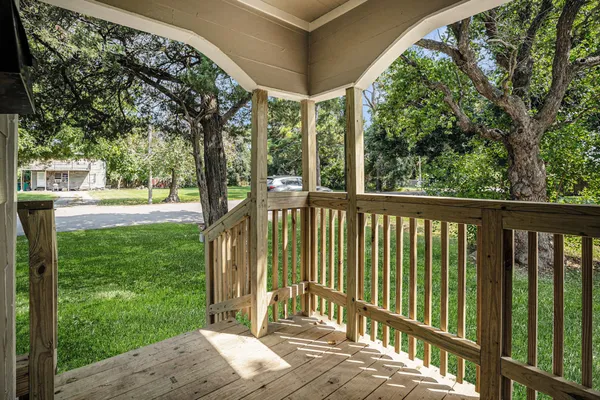 a view of backyard with green space and deck