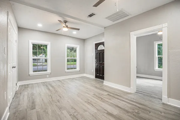 wooden floor in an empty room with a window