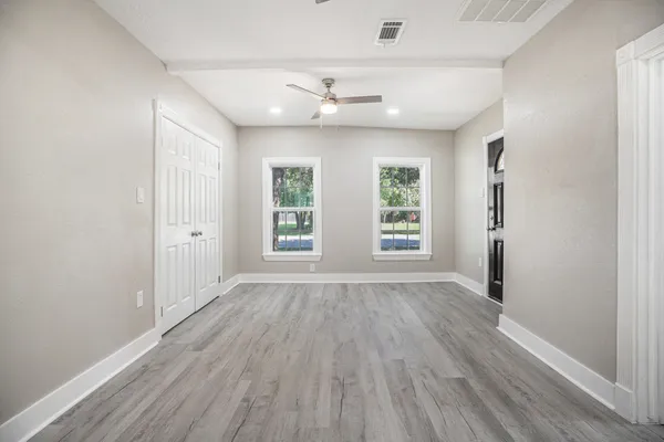 wooden floor in an empty room with a window