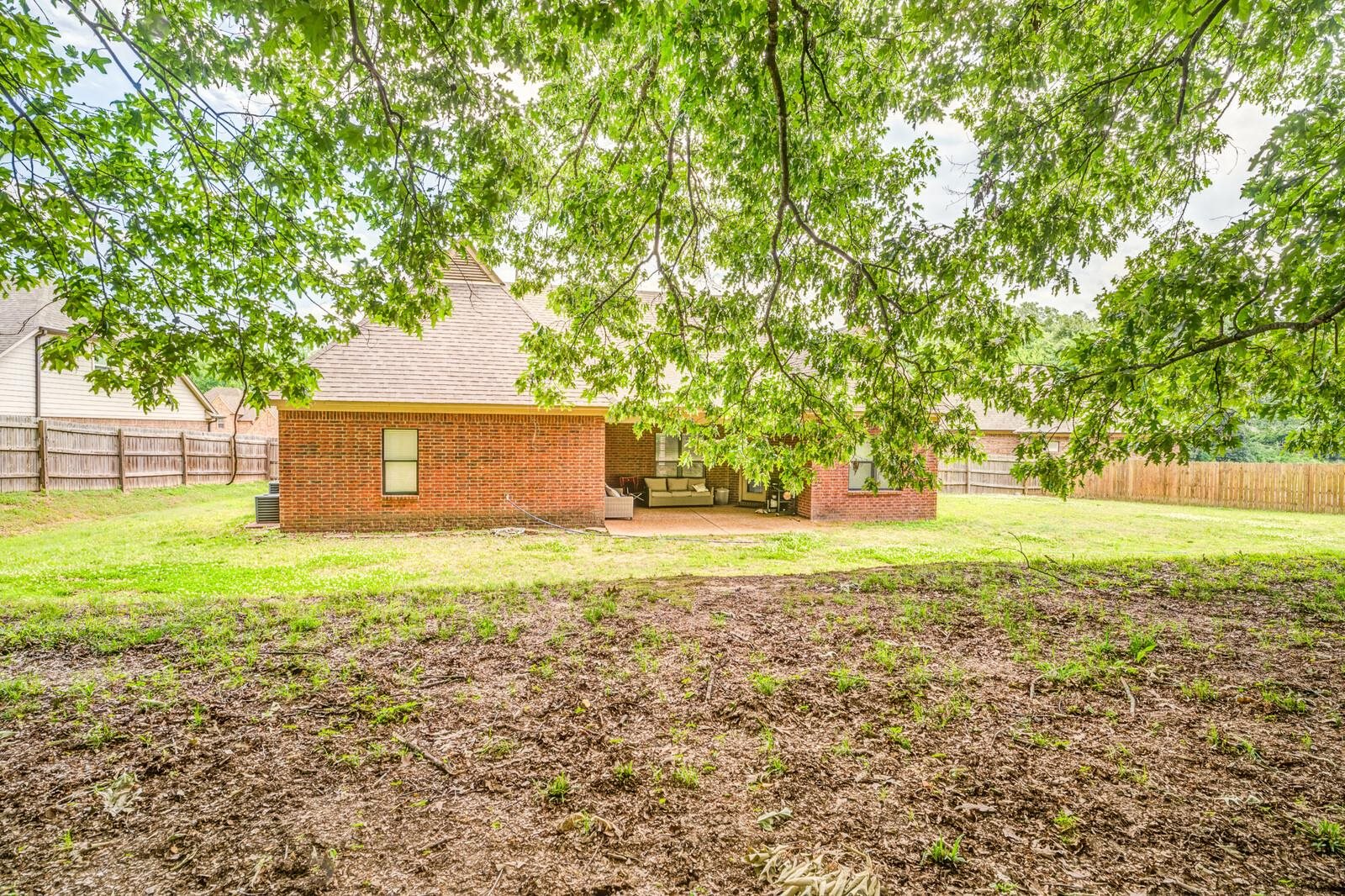 4671 Hampton Ridge Lane Bartlett, TN 38002 - Photo 38 of 40 Spacious backyard featuring a brick exterior, covered patio, and wood privacy fencing