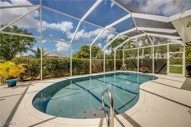 a view of a swimming pool with outdoor seating and plants