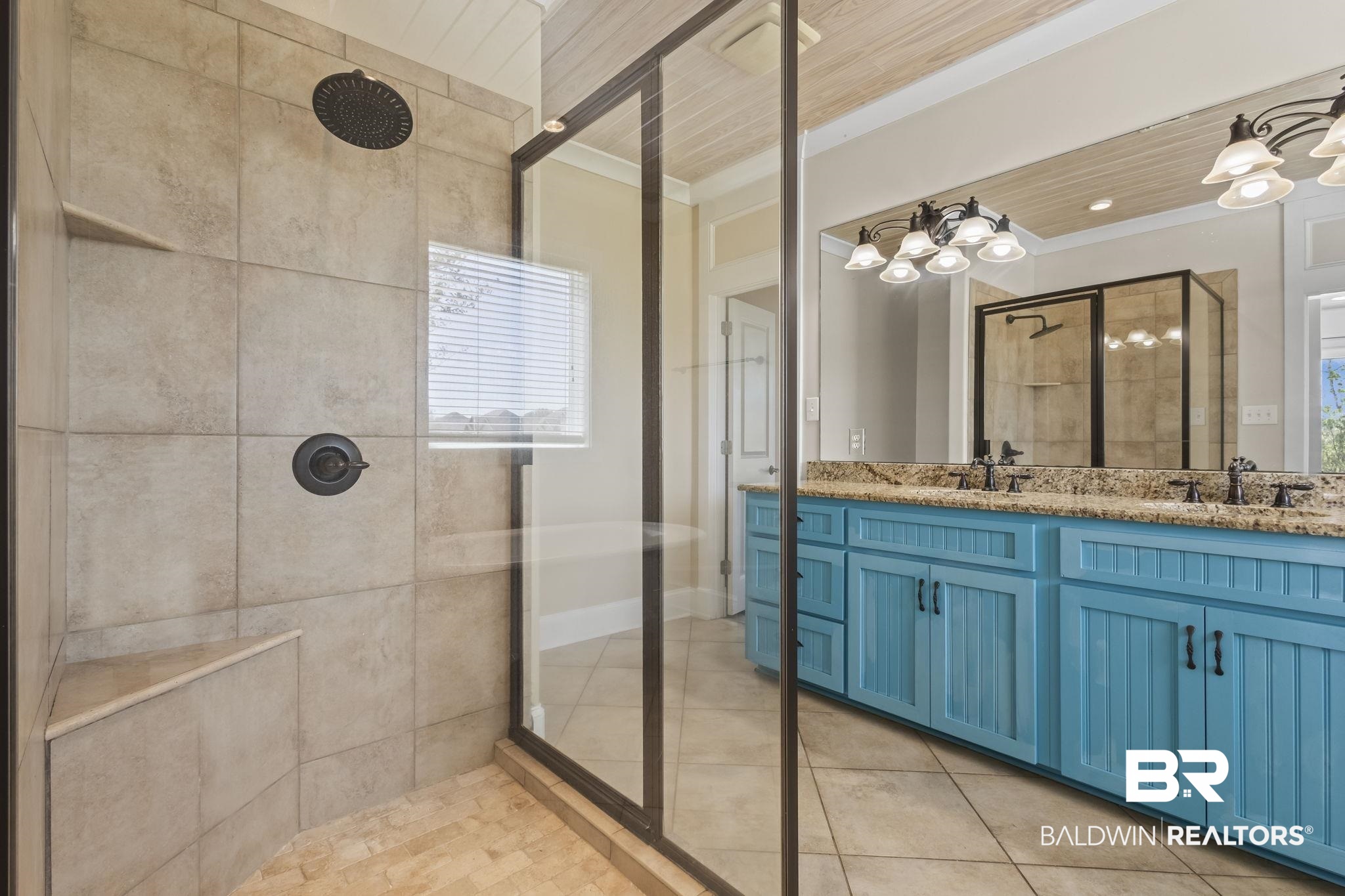7059 Rocky Rd Loop Gulf Shores, AL 36542 - Photo 23 of 46 Bathroom with tile patterned floors, tiled shower, a sink, and ornamental molding