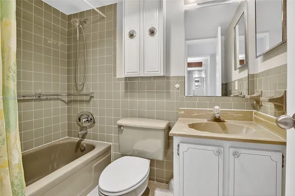a bathroom with a sink a toilet and bathtub
