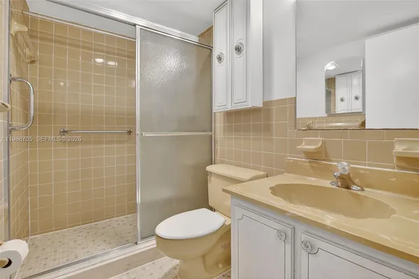 a bathroom with a sink toilet and shower