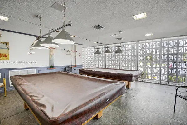 a roof deck with a couch and chairs