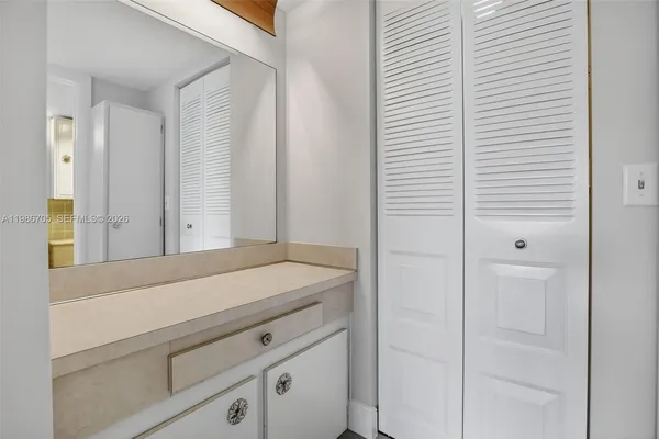 a bathroom with a shower and vanity