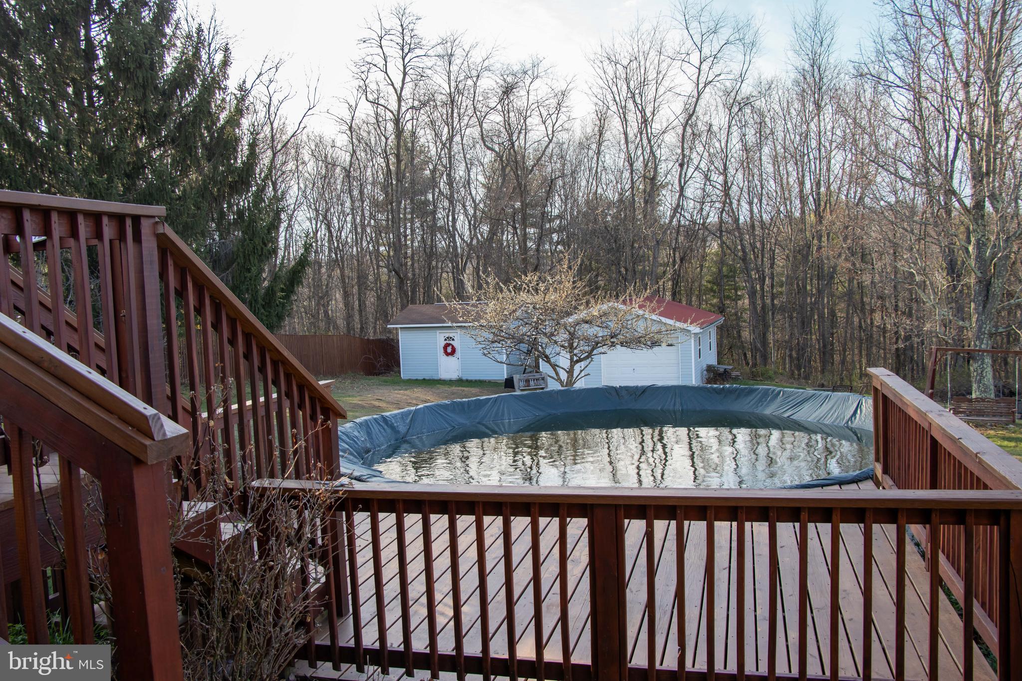 387 West Ridge Loop Road Romney, WV 26757 - Photo 37 of 58 Deck, saltwater pool, shed and garage