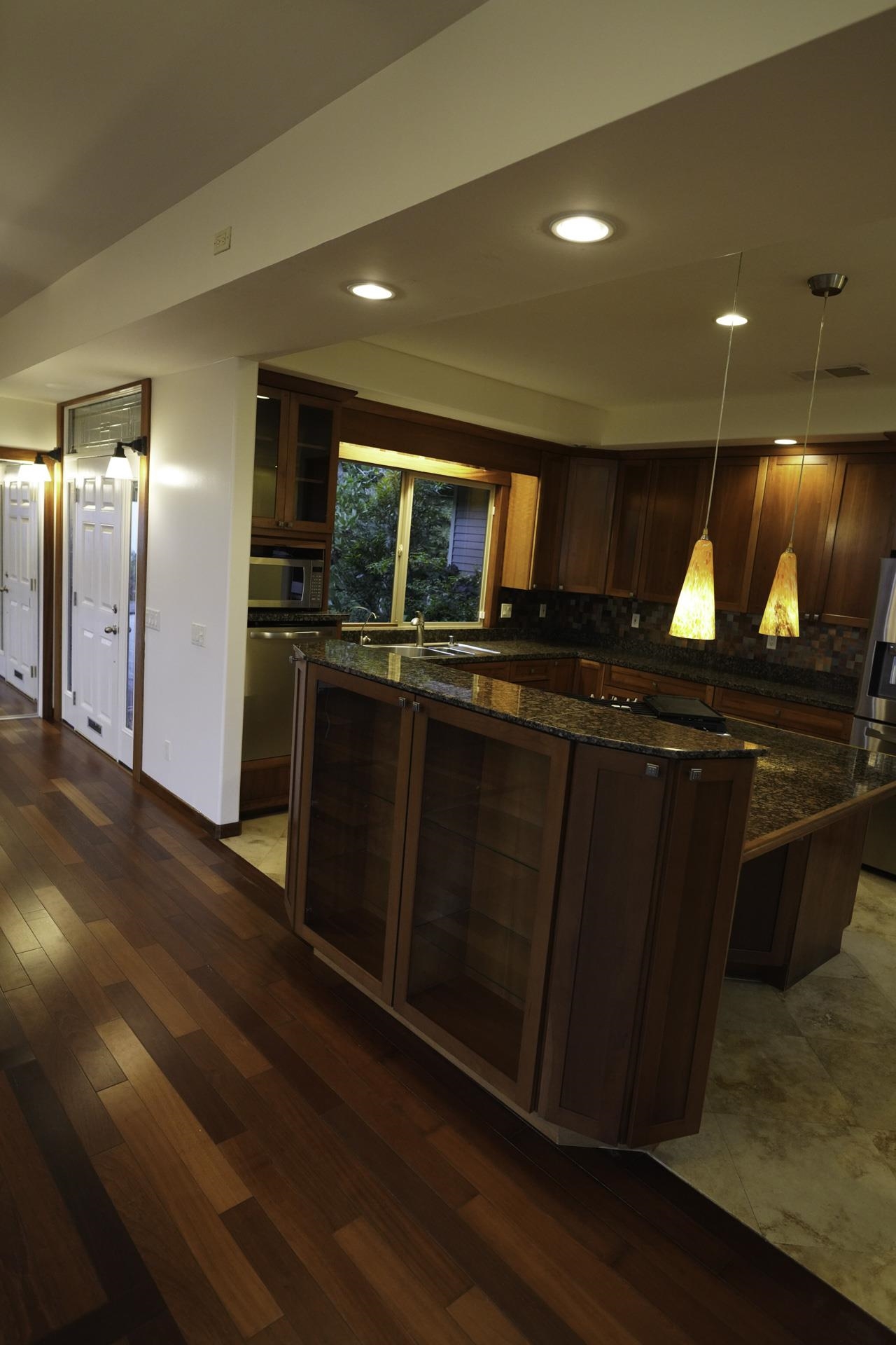 43 West Waipio Road Haiku, HI 96708 - Photo 26 of 44 a kitchen with kitchen island granite countertop wooden floors and a sink