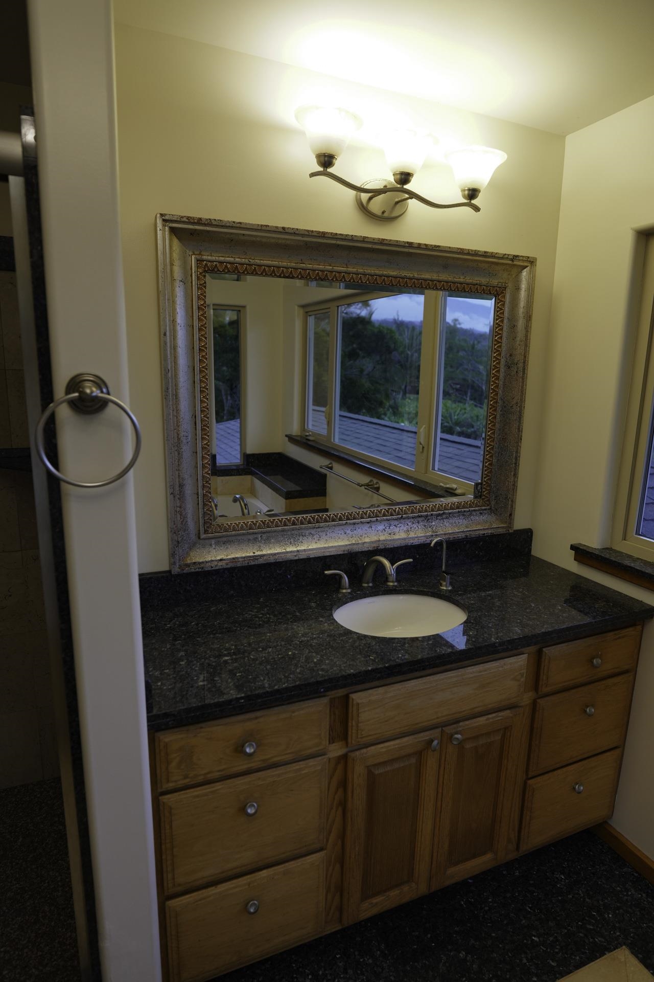 43 West Waipio Road Haiku, HI 96708 - Photo 9 of 44 a bathroom with a granite countertop sink and a mirror
