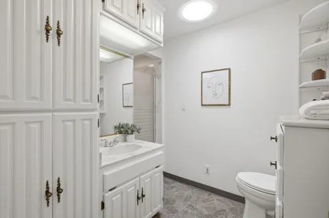 a bathroom with a sink a toilet and shower
