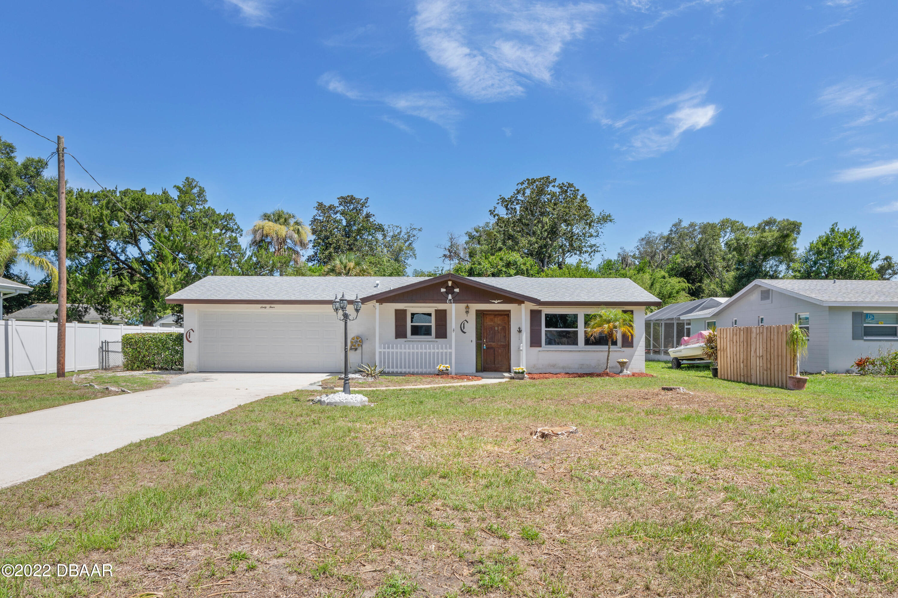 64 Cumberland Avenue Ormond Beach, FL 32174 - Photo 1 of 38 a house that has a tree in front of it