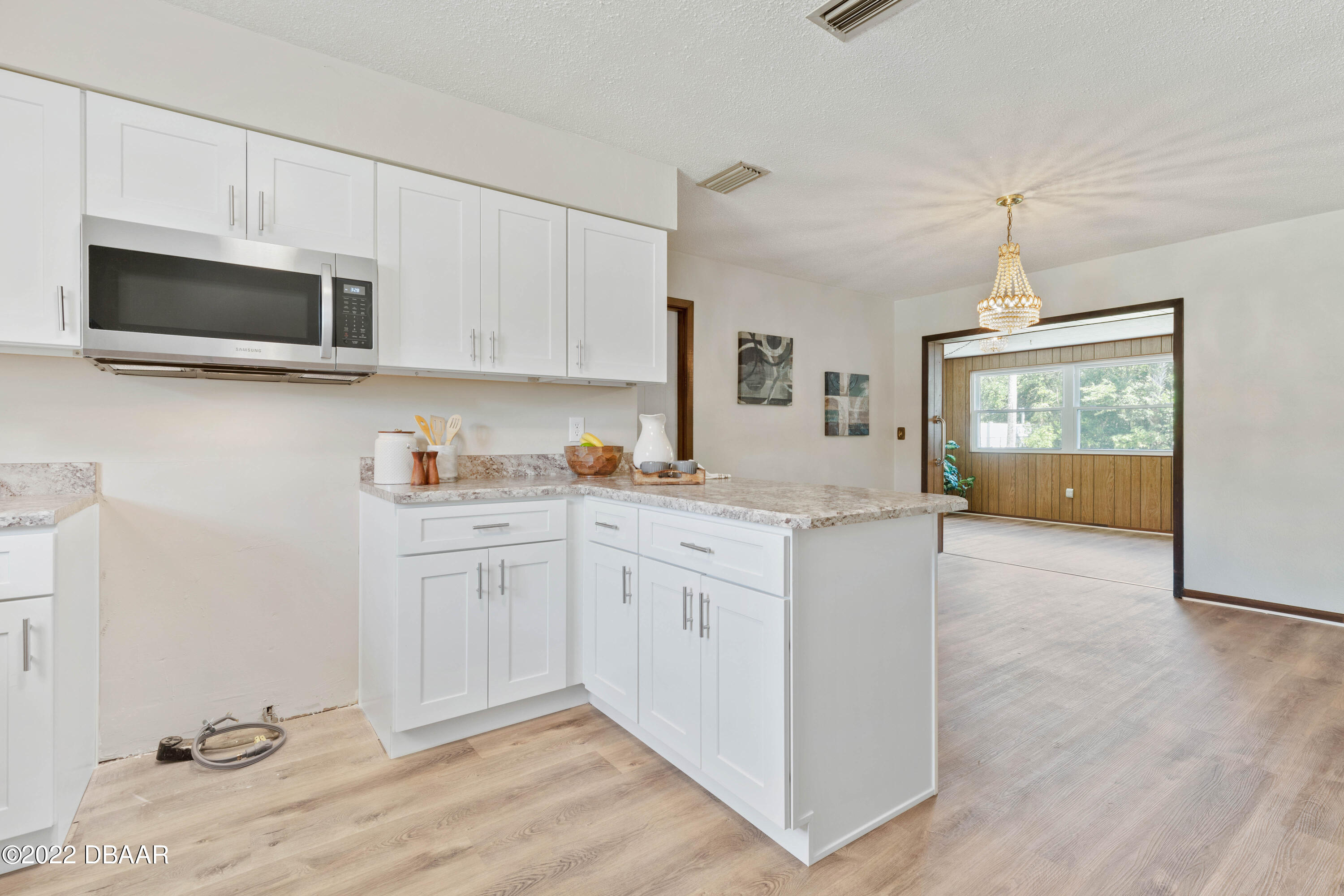 64 Cumberland Avenue Ormond Beach, FL 32174 - Photo 12 of 38 a kitchen with stainless steel appliances granite countertop a stove a sink and a microwave