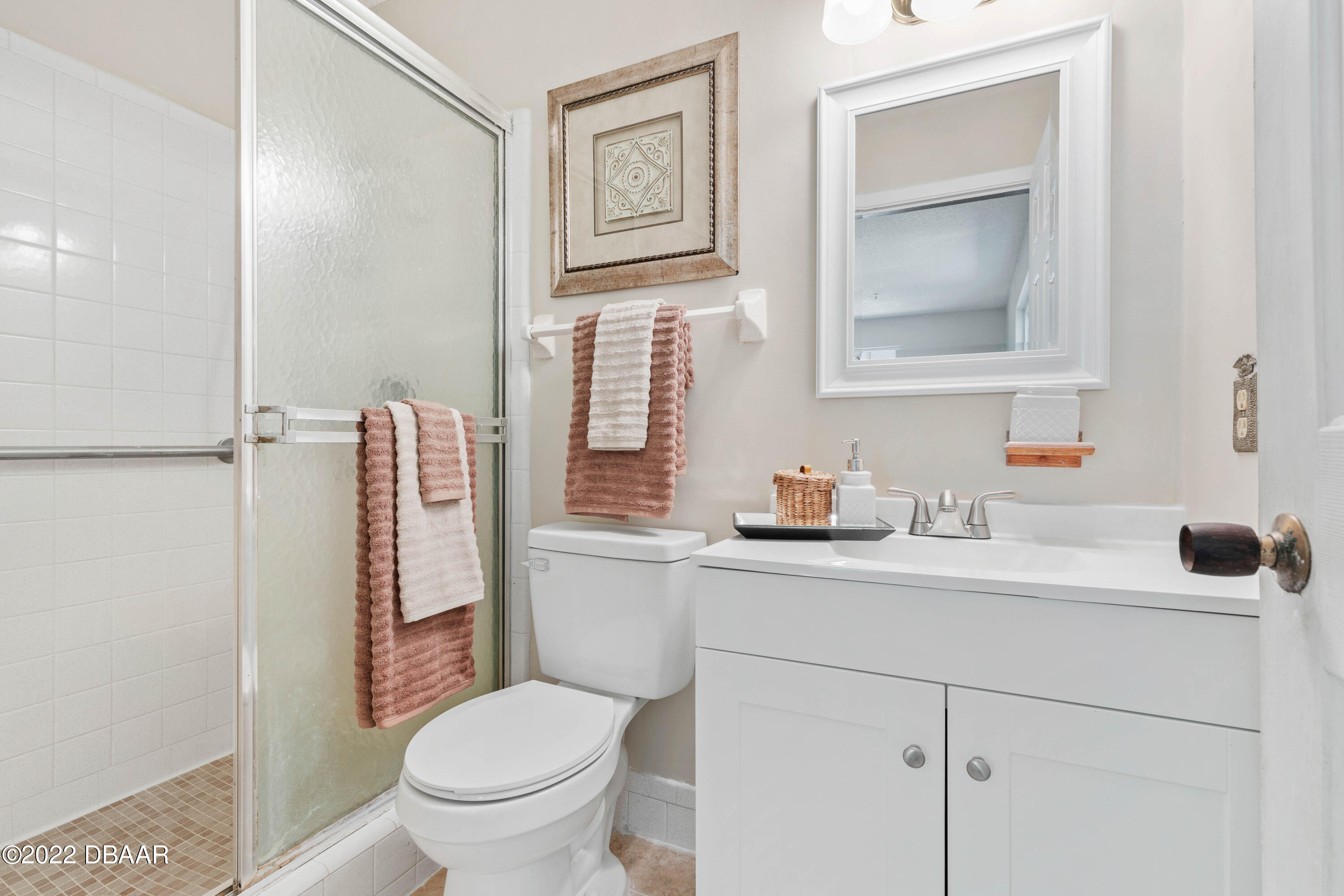 64 Cumberland Avenue Ormond Beach, FL 32174 - Photo 19 of 38 a bathroom with a toilet sink vanity and mirror