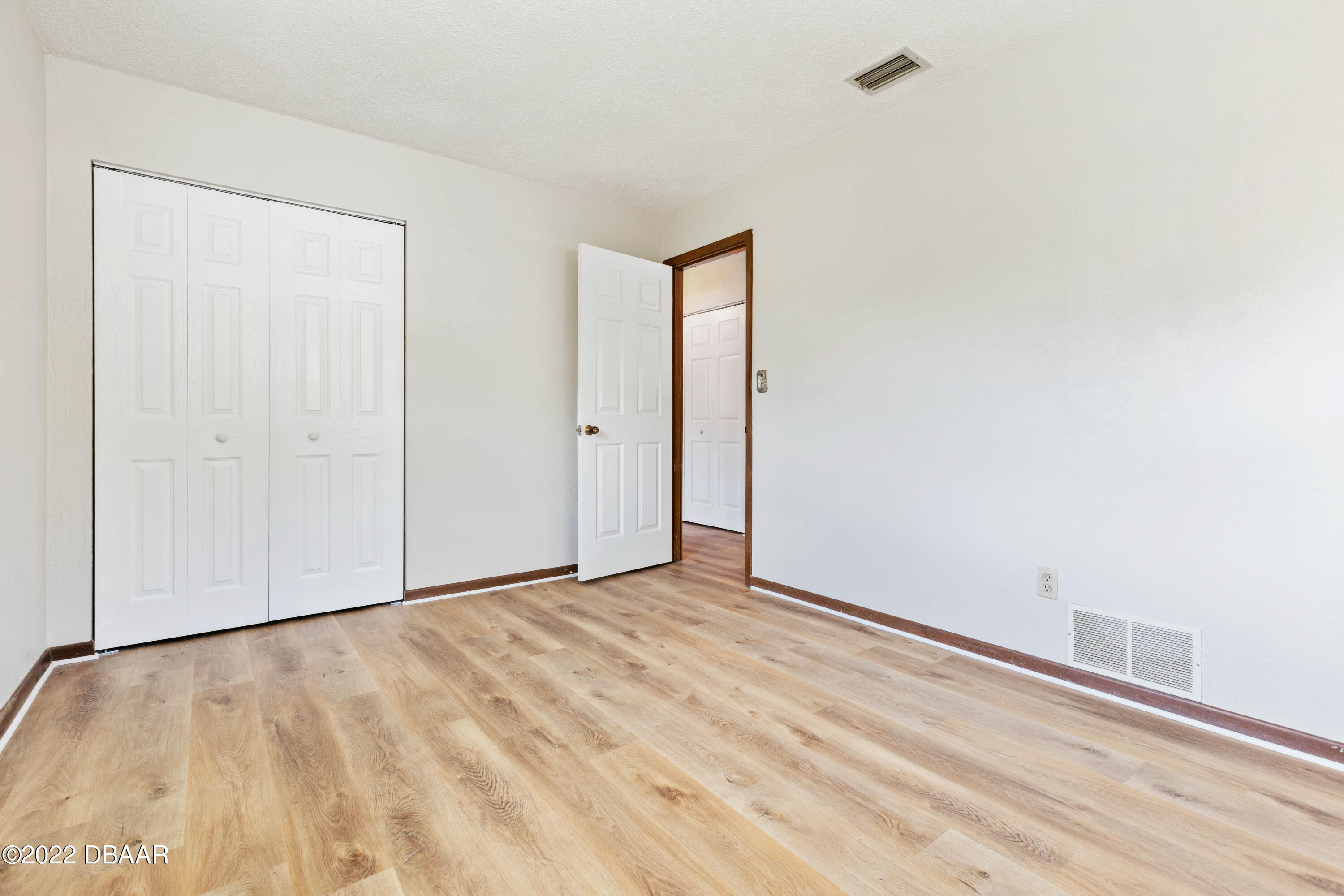 64 Cumberland Avenue Ormond Beach, FL 32174 - Photo 21 of 38 a view of an empty room with wooden floor