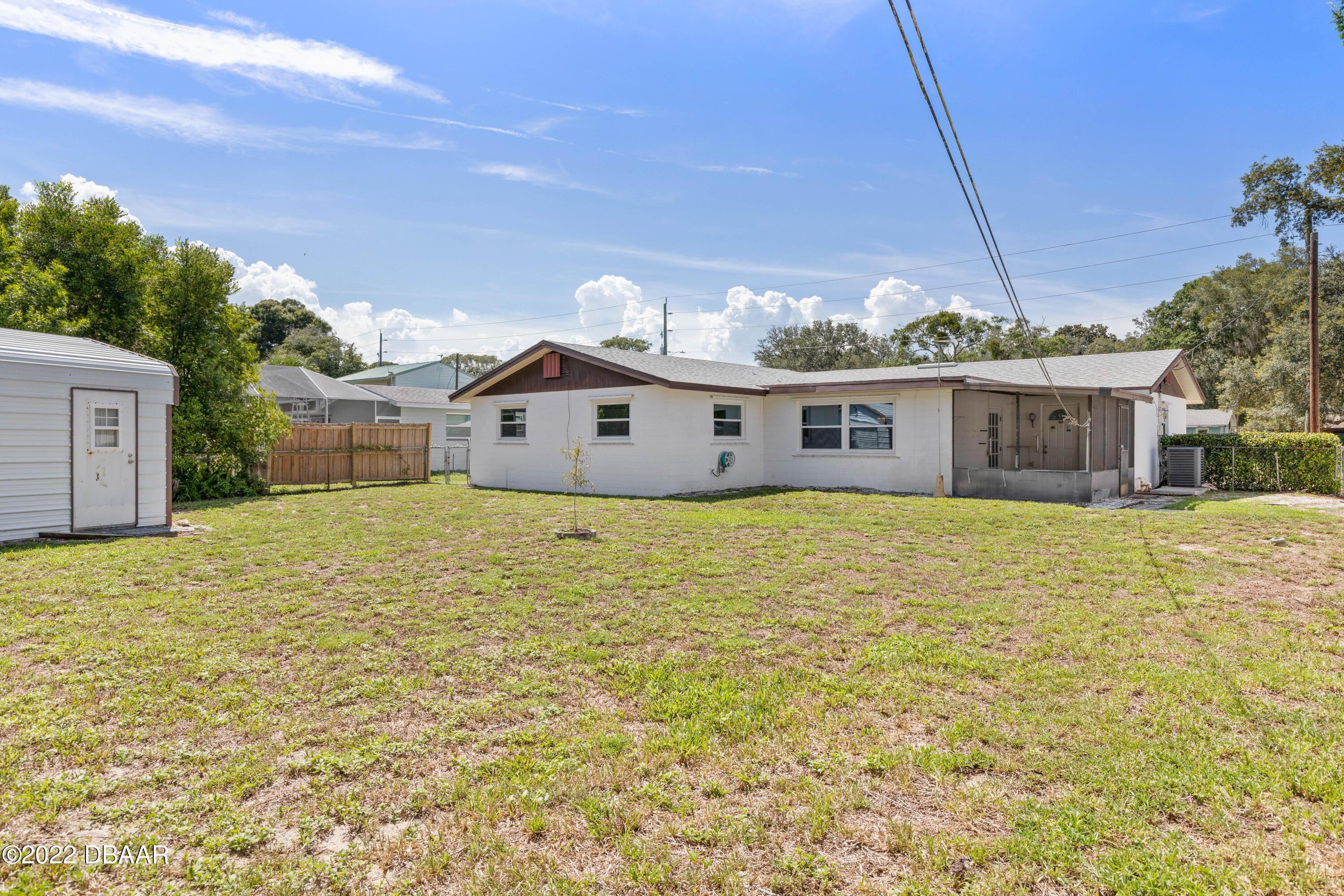64 Cumberland Avenue Ormond Beach, FL 32174 - Photo 28 of 38 a front view of a house with a garden
