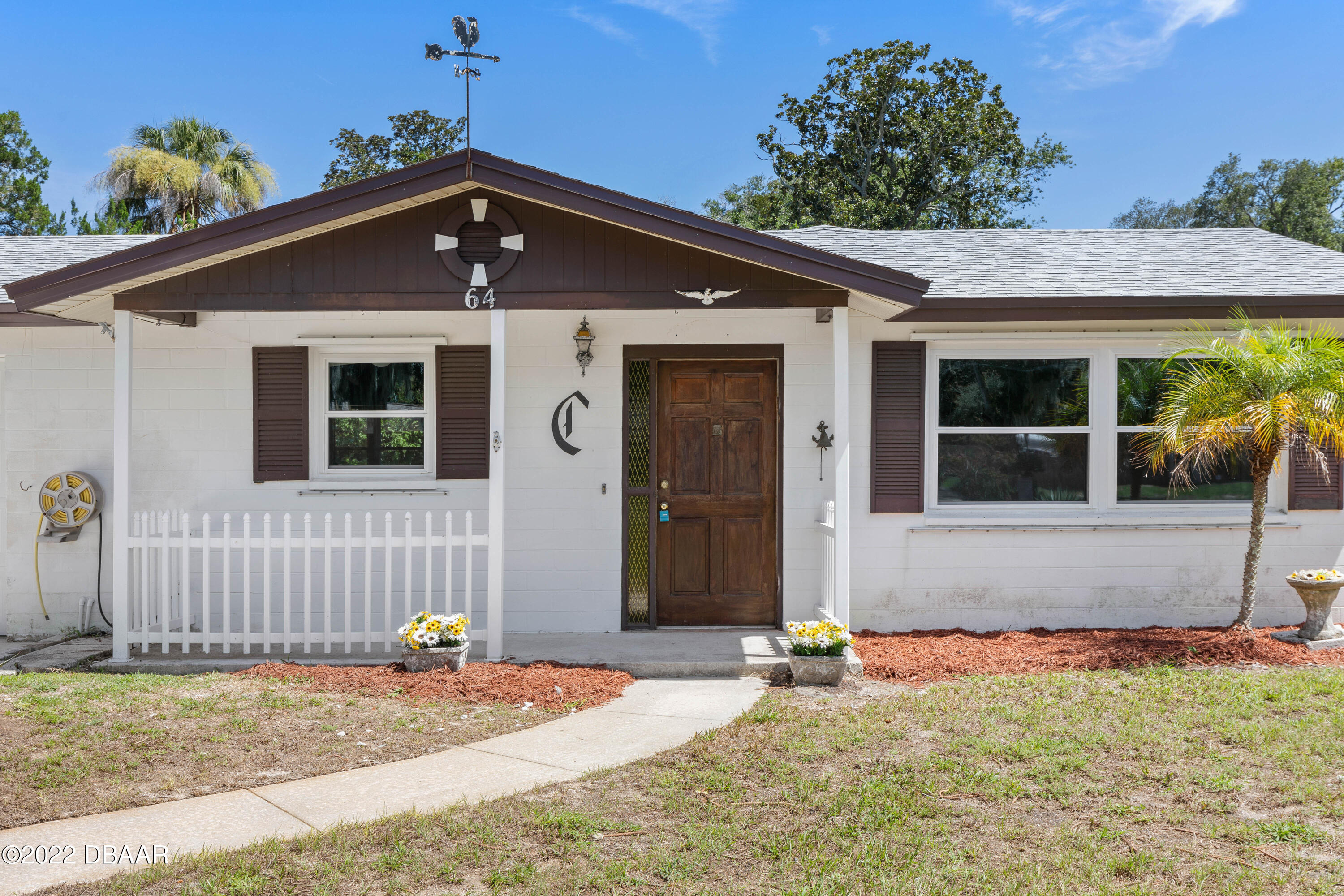 64 Cumberland Avenue Ormond Beach, FL 32174 - Photo 3 of 38 a front view of a house with a yard