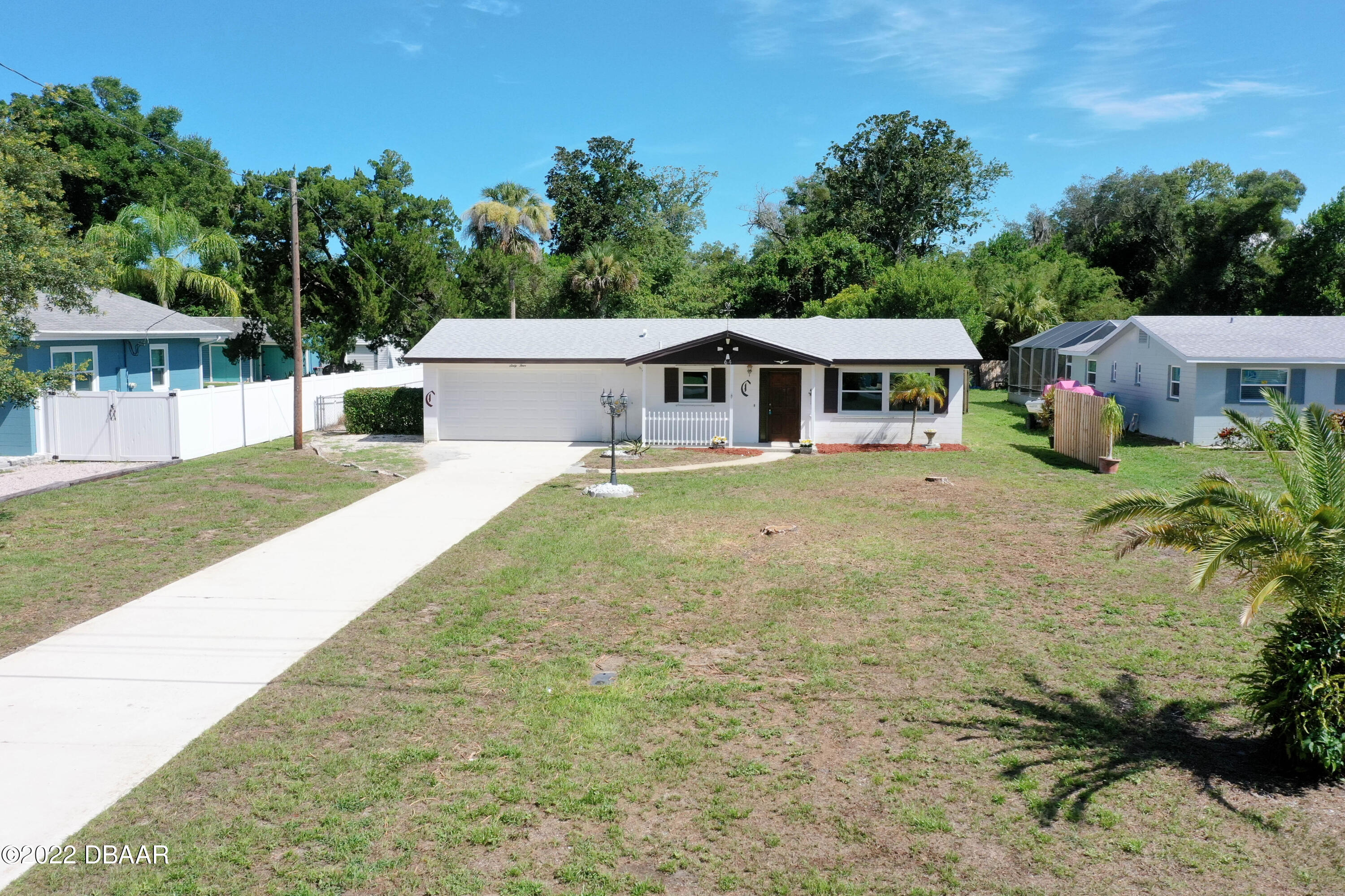 64 Cumberland Avenue Ormond Beach, FL 32174 - Photo 32 of 38 a view of a house with a yard and fence