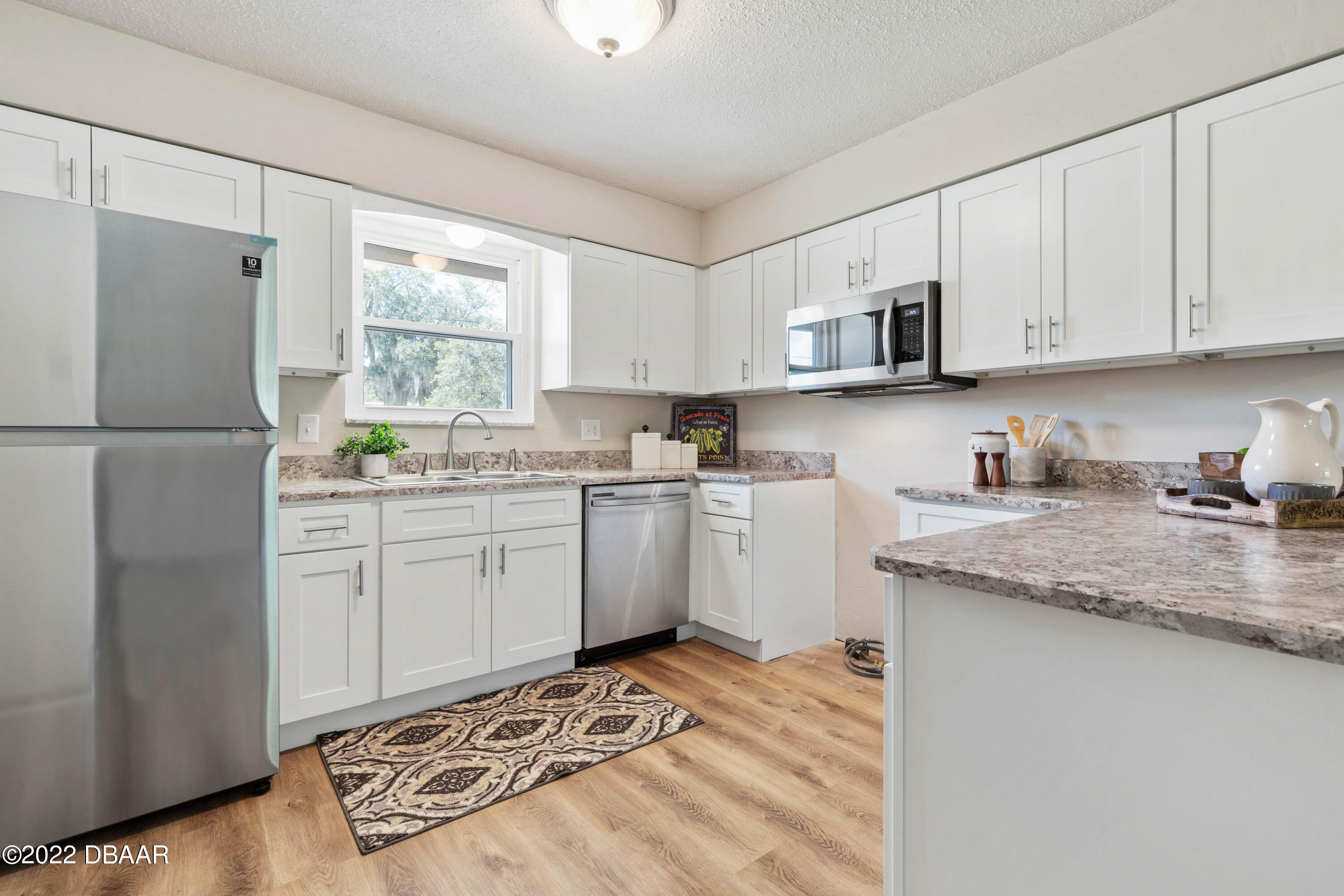 64 Cumberland Avenue Ormond Beach, FL 32174 - Photo 10 of 38 a kitchen with a white cabinets and white appliances