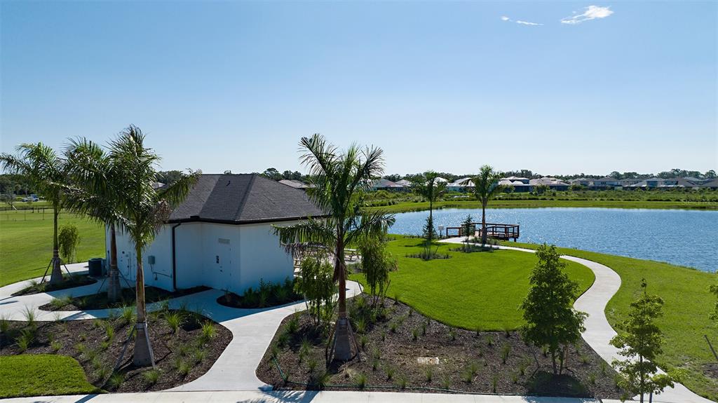 10770 Eclipse Street Sarasota, FL 34241 - Photo 31 of 48 a view of a swimming pool with a table and chairs