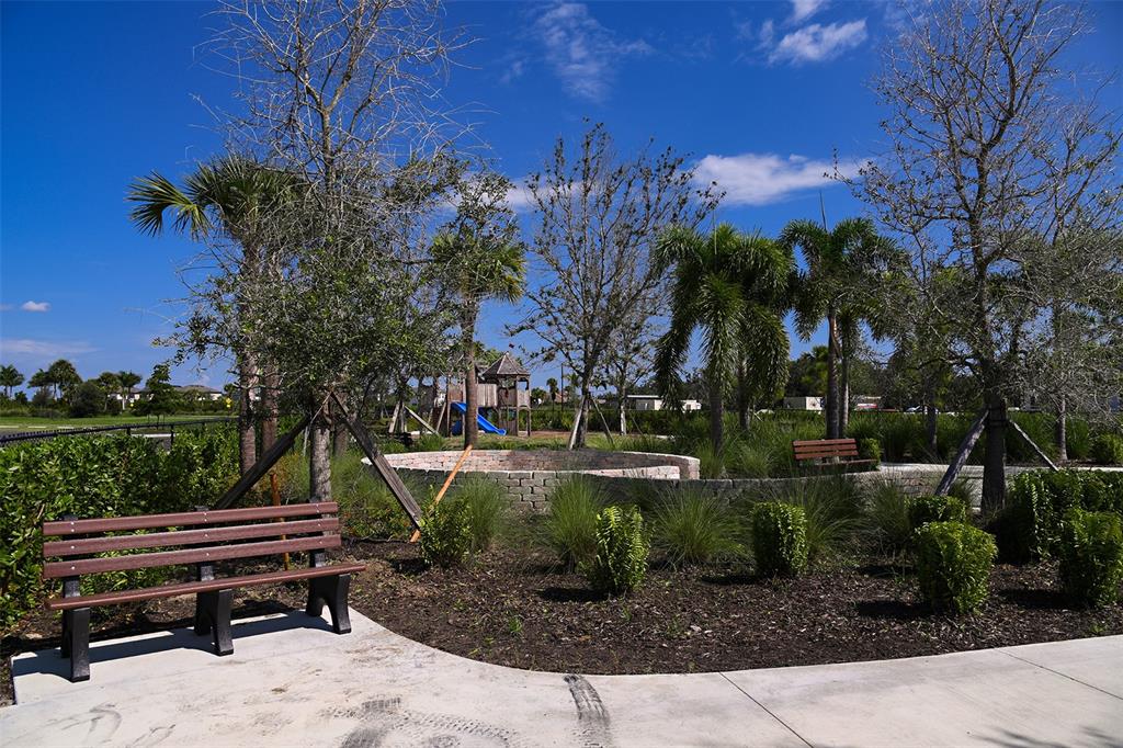 10770 Eclipse Street Sarasota, FL 34241 - Photo 39 of 48 a backyard of a house with lots of green space and fountain