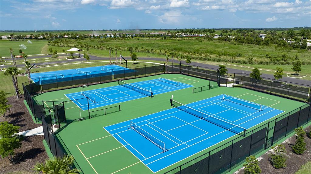 10770 Eclipse Street Sarasota, FL 34241 - Photo 47 of 48 a view of a tennis court with seating area and furniture