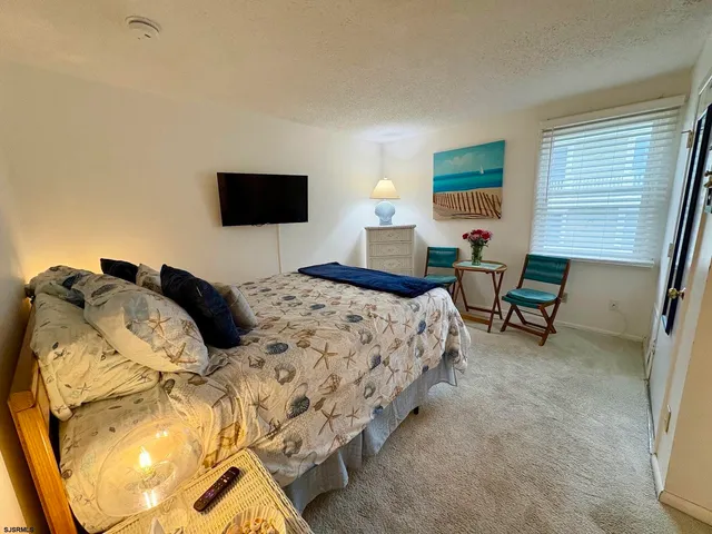 a bedroom with a bed and a mirror