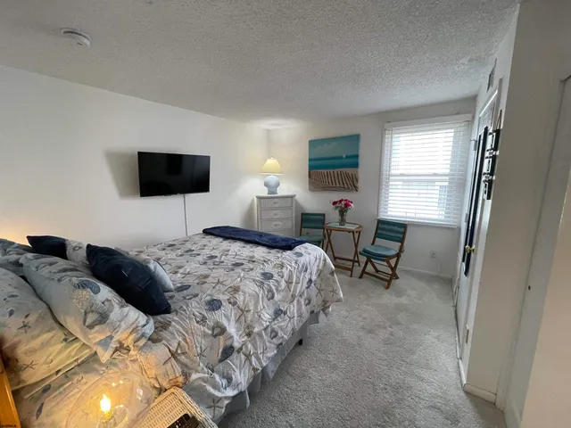 a bedroom with a bed and a potted plant