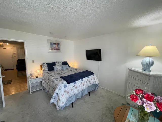 a bed room with a bed and a chair