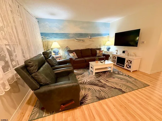 a living room with furniture and a lamp