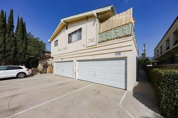 a view of a car park in front of house