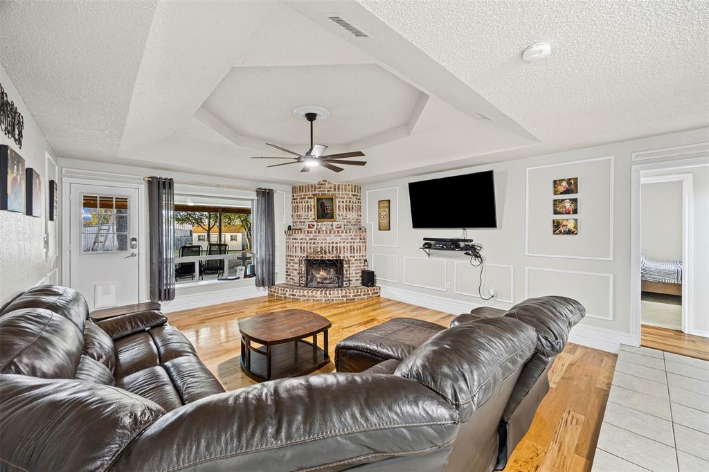 112 Saddle Hills Road Burleson, TX 76028 - Photo 11 of 38 a living room with furniture and a flat screen tv