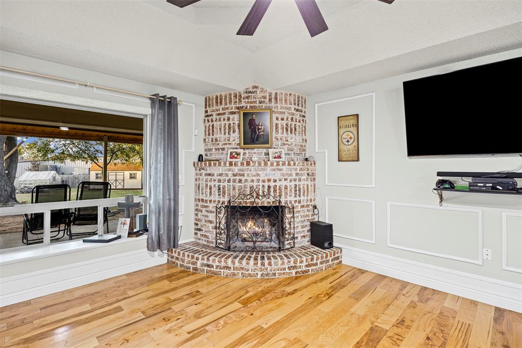 112 Saddle Hills Road Burleson, TX 76028 - Photo 13 of 38 a living room with furniture and a fireplace