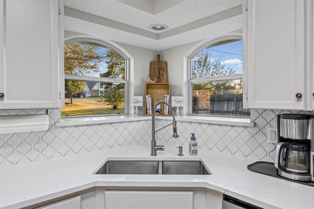 112 Saddle Hills Road Burleson, TX 76028 - Photo 16 of 38 a kitchen with a sink and a window